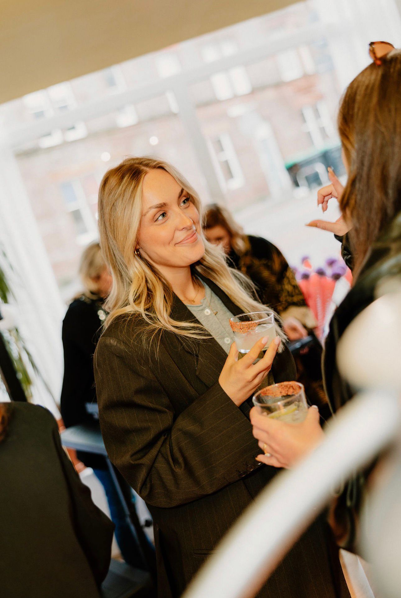Guest enjoying a drink at the salon window