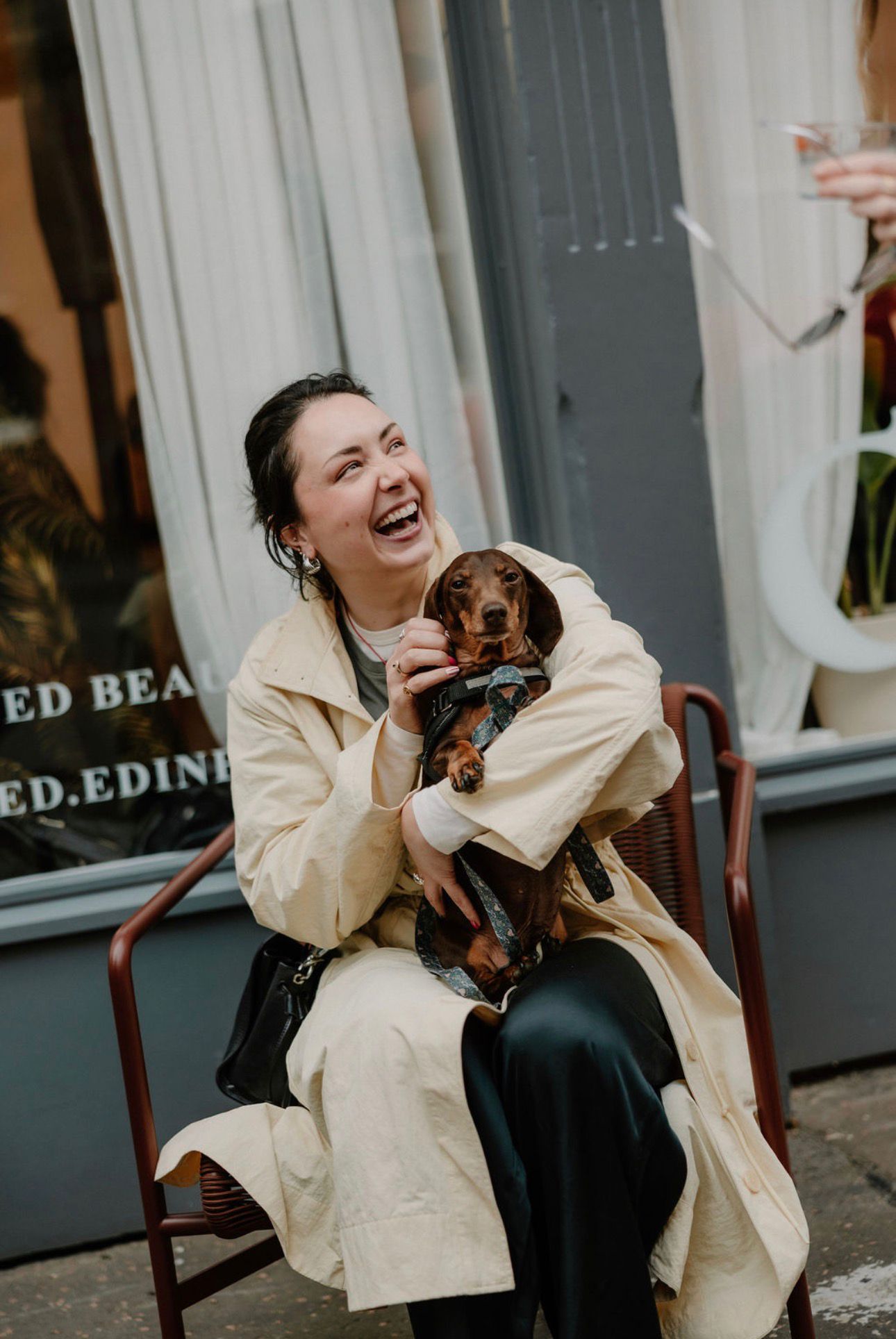 Guest with her dachshund outside the salon